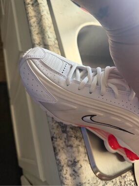 Nike White Sneakers with Black Swoosh and Red Sole Accents